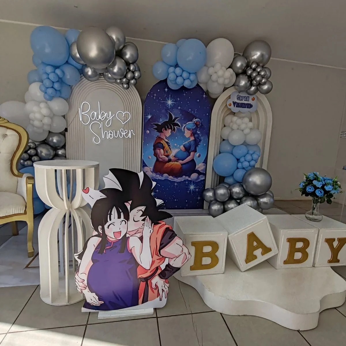 Elegant baby shower decoration with pastel balloons, floral backdrop, welcome board, and themed stage setup.